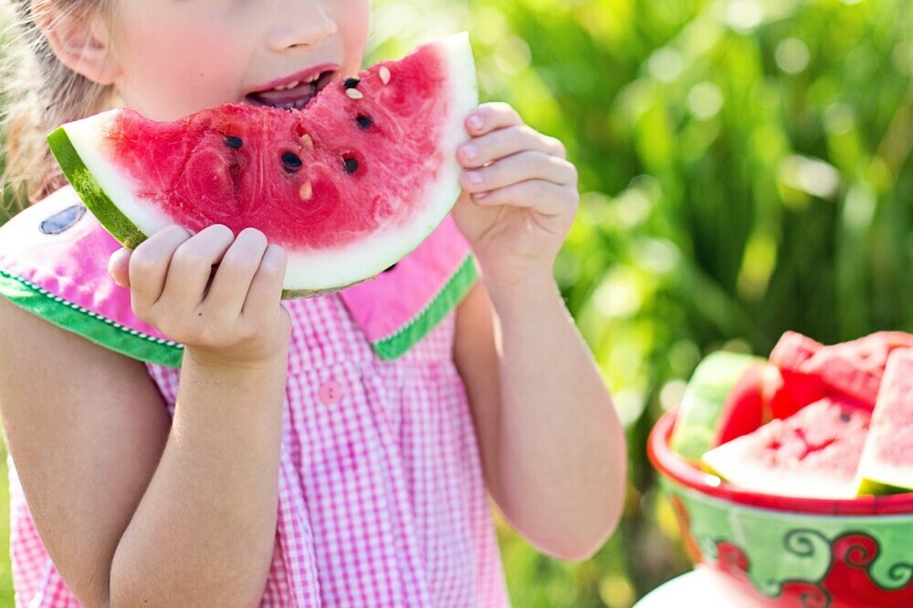 A child is eating watermelon